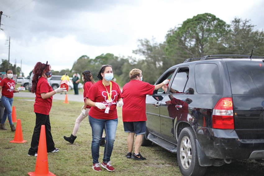 Volunteers hands out food at the drive-thru.